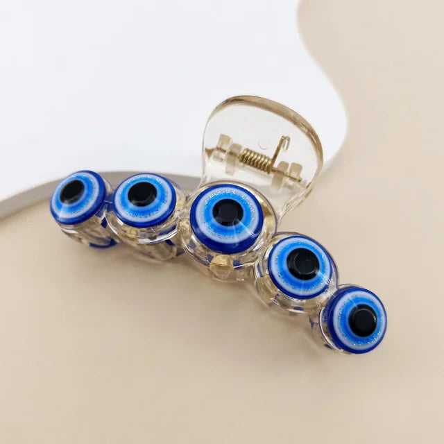 Vintage evil eye hair claw clip in clear acrylic with blue eye detail — Solara Gold